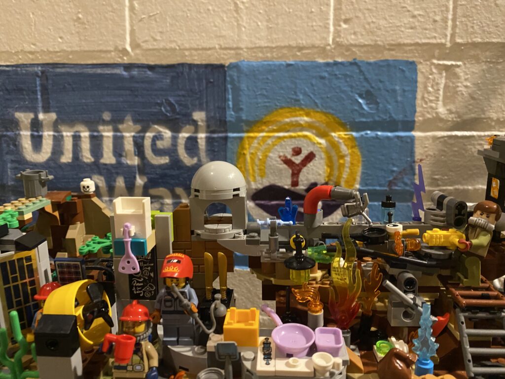 Lego Meth Lab in front of United Way logo. Photo by Travis Mateer for Western Montana News. 