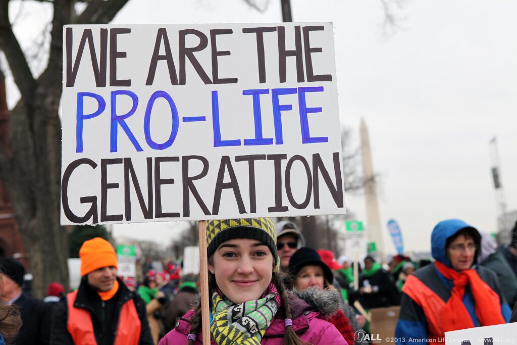 A young woman holds a sign that reads, "We are the Pro-Life generation" during March For Life. Source: American Life League.