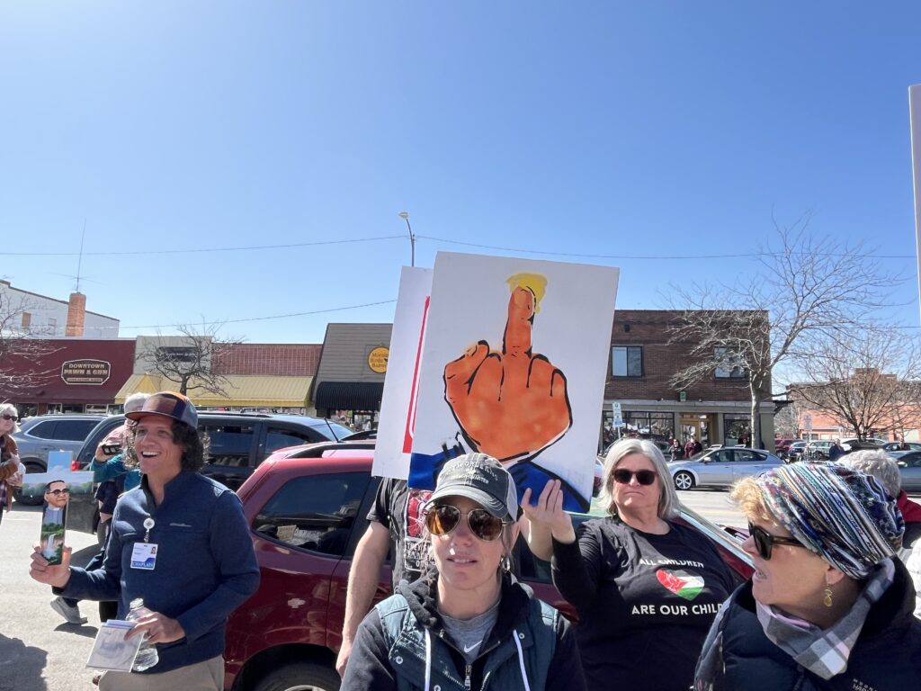 Former Missoula County Public Schools Board Trustee Grace Decker shows off her protest sign.