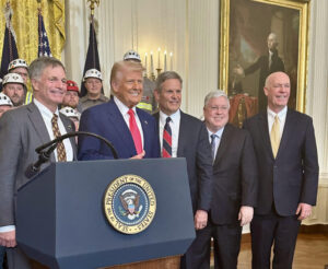 Montana Governor Greg Gianforte stands with President Trump and coal workers