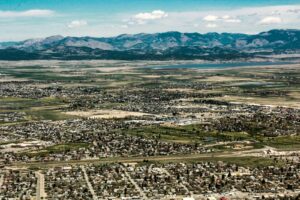 The scenic landscape of Helena, Montana with vast fields and mountain views.