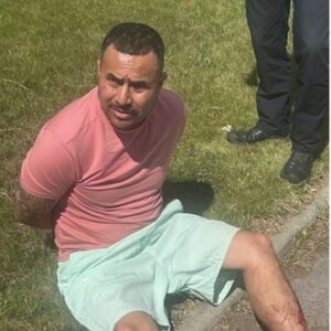 Man Detained on Grass by Law Enforcement
