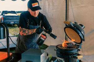 A chef uses flame-searing techniques