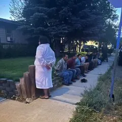 Residents Await Outside Home During Emergency