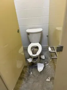 Broken Toilet in Bathroom Stall