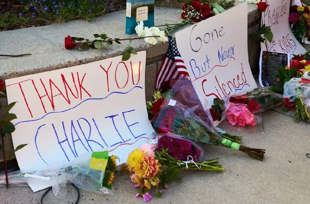 Signs at the memorial at the UM Oval commemorate Charlie Kirk and call for prayers for Kirk's family