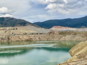 Open Pit Mine with Tailings Pond and Surrounding Hills