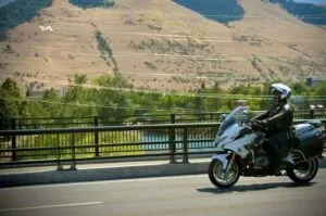 Police Officer on Motorcycle Patrol in Hilly Locale
