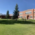 Historic School Building with Scenic Mountain Backdrop