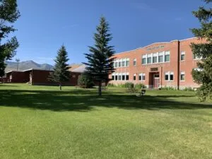 Historic School Building with Scenic Mountain Backdrop