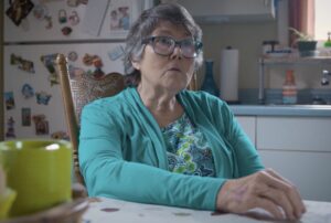 Elderly Woman in a Bright Kitchen Setting