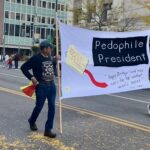 Protest Banner at Street Parade Addressing Political Controversy