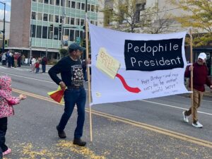 Protest Banner at Street Parade Addressing Political Controversy