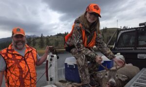 Hunting Success: Father and Daughter with Deer