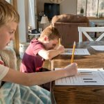 Homework at Home: Siblings Focused on Worksheets