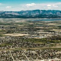 Photo by Savannah Welna The scenic landscape of Helena, Montana with vast fields and mountain views.