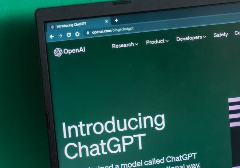 Laptop screen displaying the introductory page of ChatGPT on OpenAI's website.