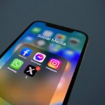 Photo by Julian a close up of a cell phone with social media icons