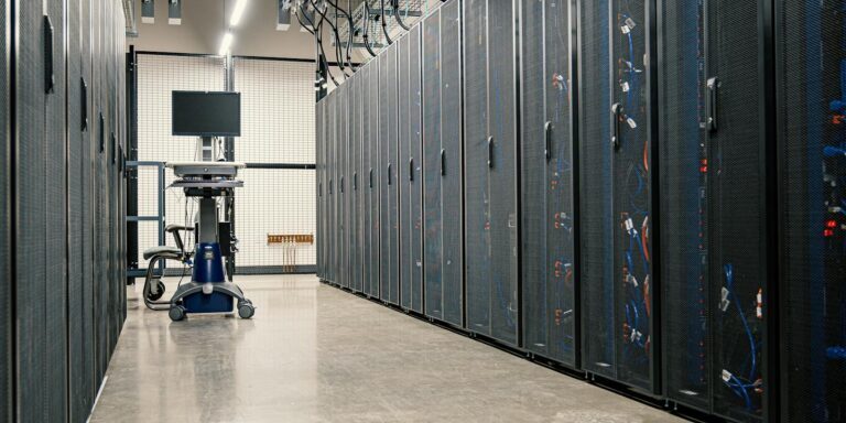 Modern data center corridor with server racks and computer equipment. Ideal for technology and IT concepts.