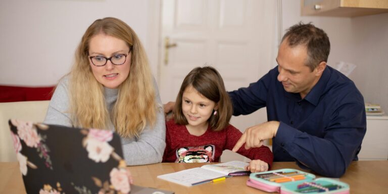 woman in blue sweater beside girl in blue sweater