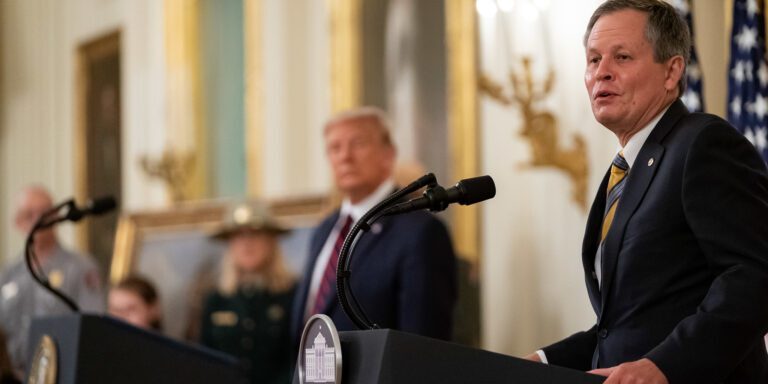 President Donald J. Trump listens as Senator Steve Daines, R-Mont., delivers remarks
