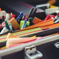 Photo by Tim Gouw A collection of colorful office supplies neatly arranged in a suitcase, perfect for professionals on the go.