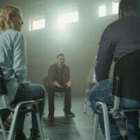 Photo by Tima Miroshnichenko A diverse group of adults in a supportive discussion setting indoors with sunrays.