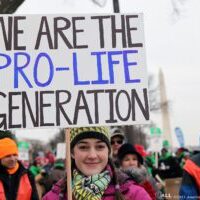 A young woman holds a sign that reads, "We are the Pro-Life generation" during March For Life A young woman holds a sign that reads, "We are the Pro-Life generation" during March For Life. Source: American Life League.