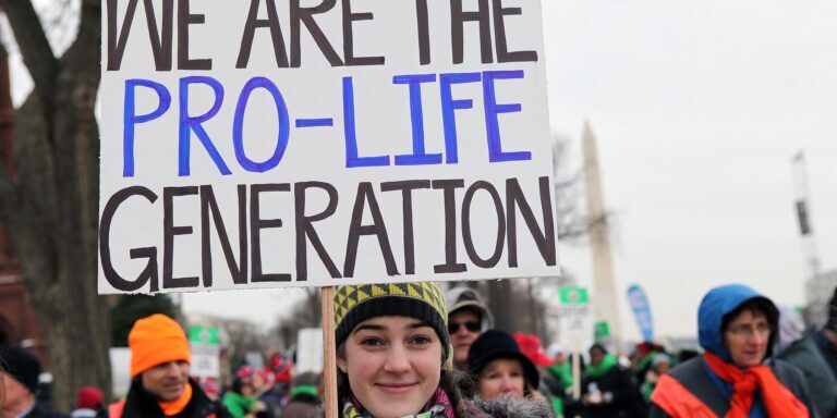 A young woman holds a sign that reads, "We are the Pro-Life generation" during March For Life. Source: American Life League.