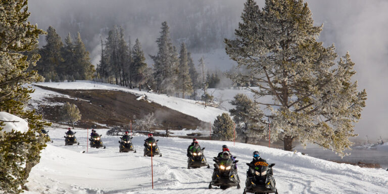 Guided snowmobile tour along Firehole River