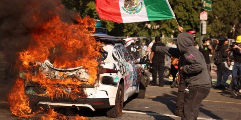 Protest Scene with Burning Car and Mexican Flag