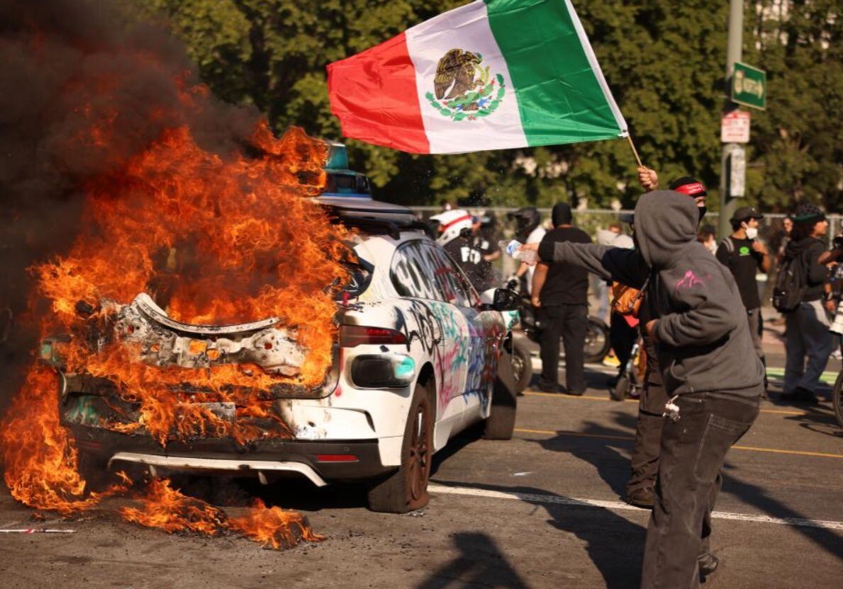 Protest Scene with Burning Car and Mexican Flag Protest Scene with Burning Car and Mexican Flag