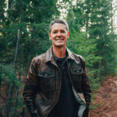 Smiling Man in Leather Jacket Amidst Forest Smiling Man in Leather Jacket Amidst Forest