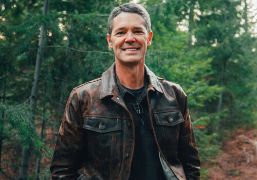 Smiling Man in Leather Jacket Amidst Forest Smiling Man in Leather Jacket Amidst Forest