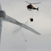 Helicopter attempts to de-ice turbine blade on Swedish wind turbine. Helicopter attempts to de-ice turbine blade on Swedish wind turbine.