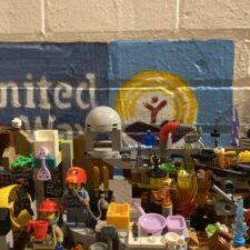 Lego Meth Lab in front of United Way logo. Photo by Travis Mateer for Western Montana News.