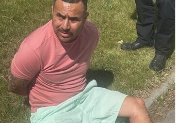 Man Detained on Grass by Law Enforcement Man Detained on Grass by Law Enforcement