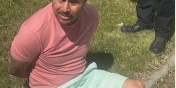 Man Detained on Grass by Law Enforcement