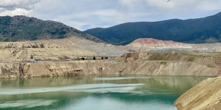 Open Pit Mine with Tailings Pond and Surrounding Hills