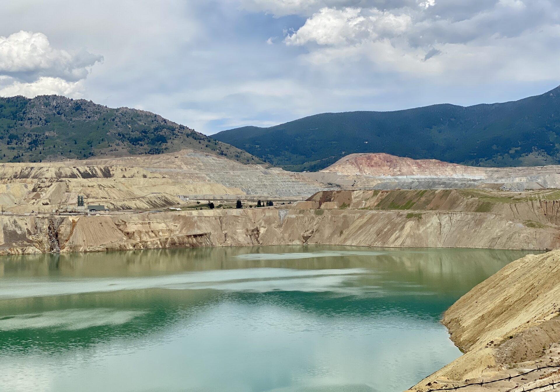 Open Pit Mine with Tailings Pond and Surrounding Hills