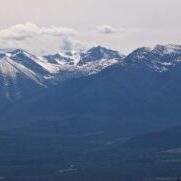 Snow-Capped Mountain Range Under Cloudy Sky Snow-Capped Mountain Range Under Cloudy Sky