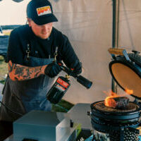 A chef uses flame-searing techniques A chef uses flame-searing techniques