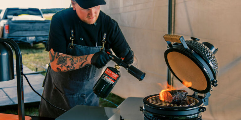 A chef uses flame-searing techniques