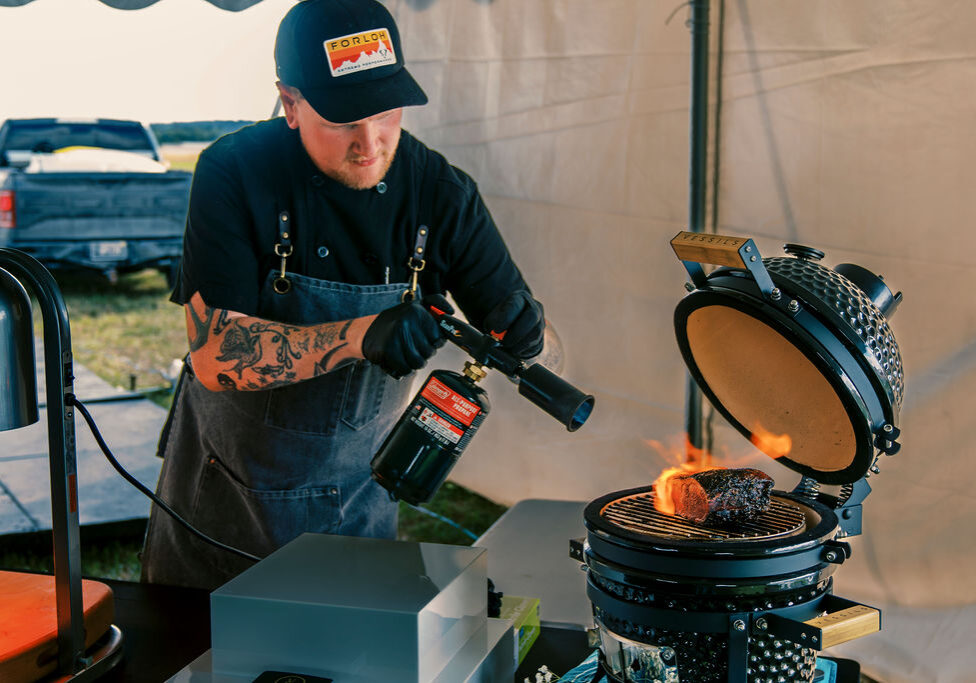 A chef uses flame-searing techniques A chef uses flame-searing techniques