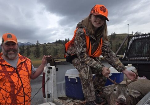Hunting Success: Father and Daughter with Deer