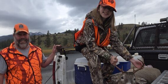 Hunting Success: Father and Daughter with Deer