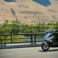 Police Officer on Motorcycle Patrol in Hilly Locale Police Officer on Motorcycle Patrol in Hilly Locale