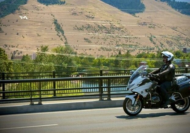 Police Officer on Motorcycle Patrol in Hilly Locale