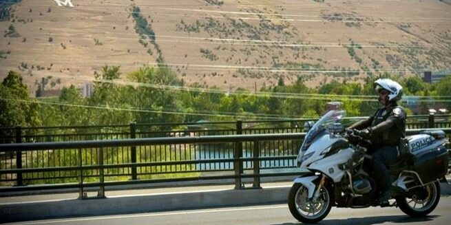 Police Officer on Motorcycle Patrol in Hilly Locale