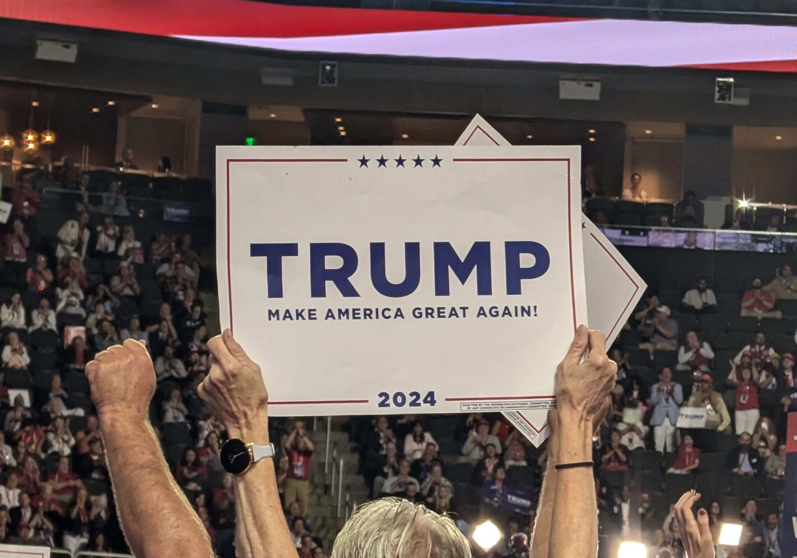 2024 RNC Convention attendee holds Trump sign